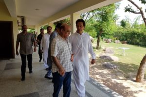 Tahir Anjum with future Prime Minister and Pervez Khattak on Aug. 01 at Bani Gala